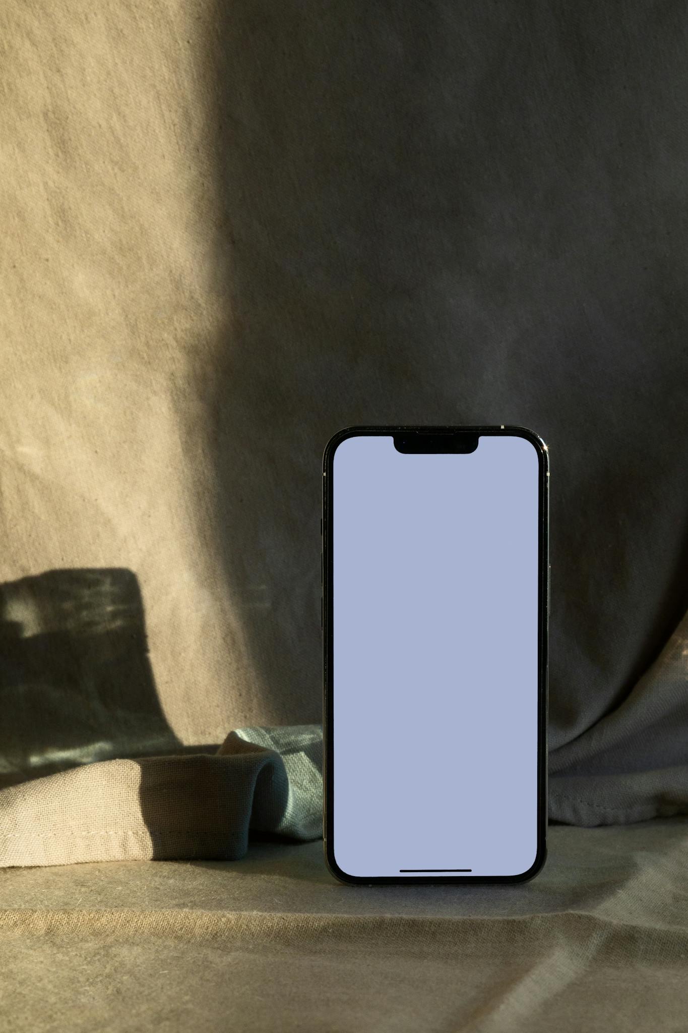 Minimalist smartphone mockup with soft shadows and neutral background, perfect for showcasing apps.